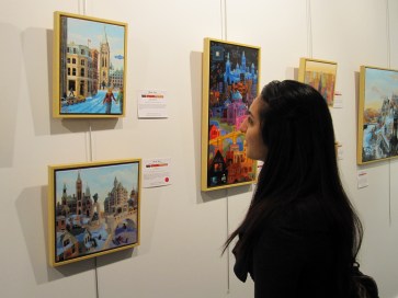 A visitor to the Gordon Harrison Gallery admires a painting by Bhat Boy (photo by Anita Malhotra)