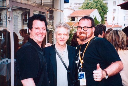 Demarbre at the 2002 Cannes Film Festival with filmmaker David Cronenberg (centre) and actor Josh Grace (left)