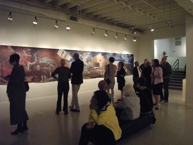 Patrons viewing Eric Stotik's large-scale 2013 untitled painting (conceived as a continuous circle but displayed linearly) at the opening of his solo exhibit at the Laura Russo Gallery in September 2013 (photo courtesy of the Laura Russo Gallery)