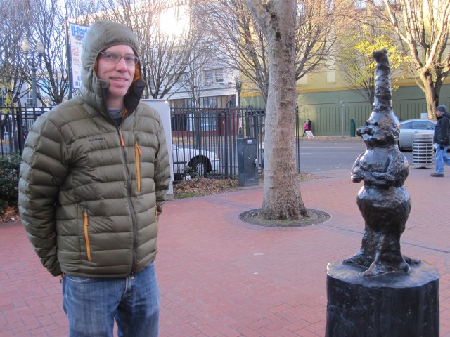 Bruce Conkle posing beside one of the figures in his trio of bronze sculptures, "Burls will be Burls," on December 7, 2013 (photo by Anita Malhotra)