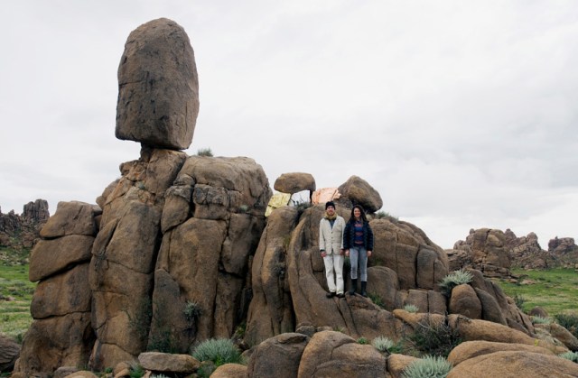 Bruce Conkle and Marne Lucas posing on "Balance Rock - Miner Threat" (metal leaf on granite)  in Mongolia's Gobi Desert in 2012 (photo by Maik Teriete)