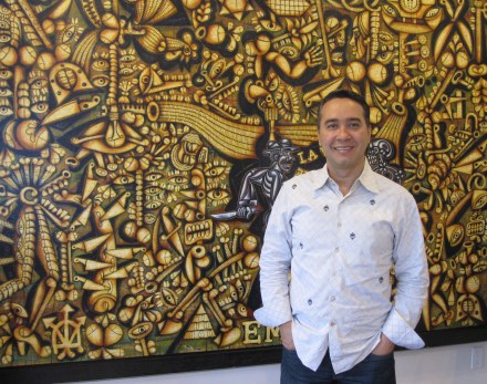 Cuban-American artist Carlos Luna posing in front of his painting "Empingated" ("Freaking Awesome") on October 11, 2014 in Miami, Florida (photo by Anita Malhotra)