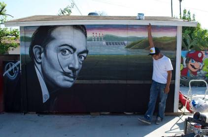 Ponce with his mural "Dali," a 2013 portrait of Salvador Dali (photo by Javier Martinez)