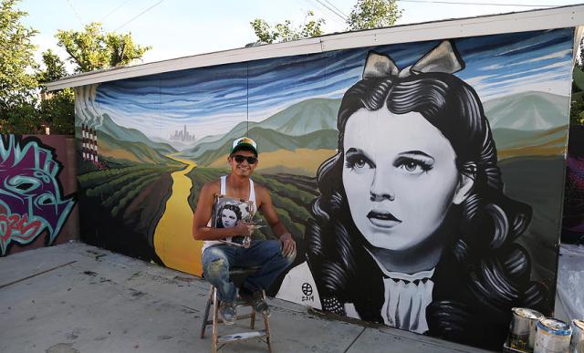 Levi Ponce with his mural "Dorothy" (photo by Javier Martinez)