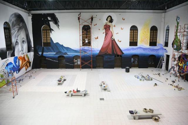 Levi Ponce (middle of scaffolding) taking a break from creating work at the Museum of Contemporary Art in the Yucatan, Mexico (photo by Alicia Anderson)