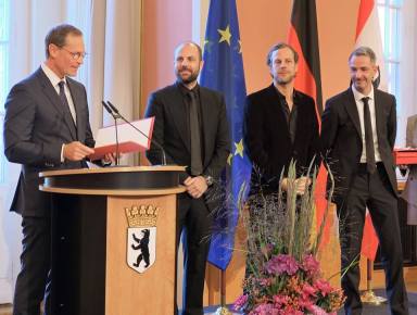 Christopher and Marc Bauder’s inauguration with the Order of Merit of the State of Berlin for the installation LICHTGRENZE (photo courtesy of WHITEvoid)