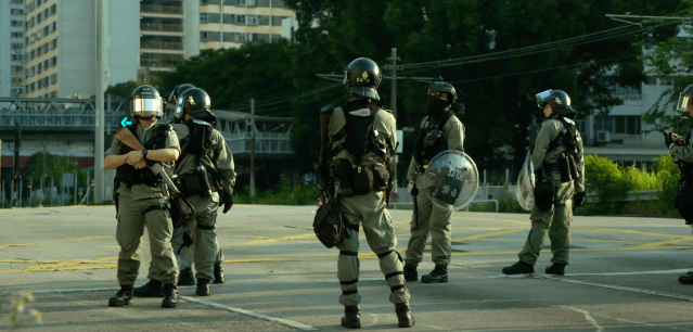 Police officers in "Hong Kong Moments" (photo courtesy of Zhou Bing)